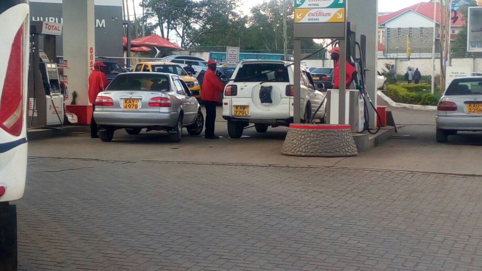 Petrol station attendants working on a Kenyan forecourt
