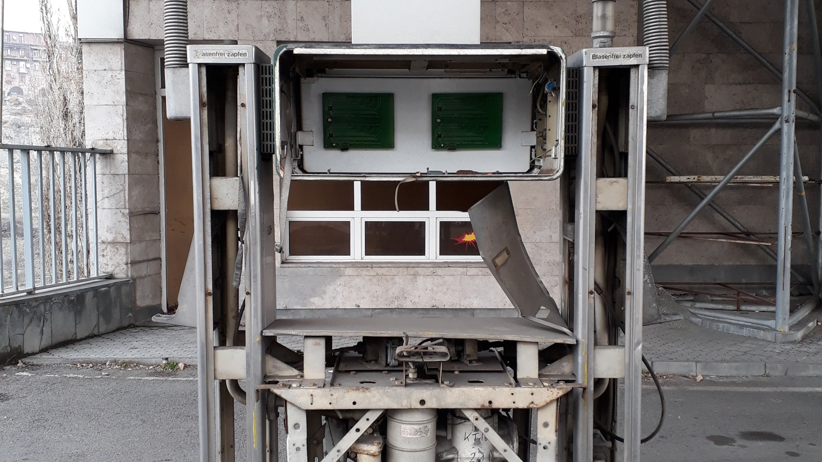 Open petrol pump cabinet showing internal dispenser equipment